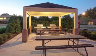 The gazebo at Sonesta Simply Suites Dallas Las Colinas includes barbecue facilities and picnic tables and benches where guests can dine and socialize.