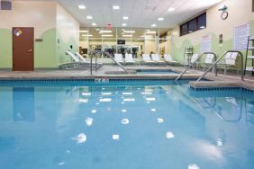 The indoor pool at Sonesta Milwaukee West Wauwatosa has an adjacent hot tub, sun loungers by the side, and is next to the fitness center.