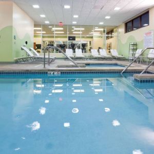 The indoor pool at Sonesta Milwaukee West Wauwatosa has an adjacent hot tub, sun loungers by the side, and is next to the fitness center.