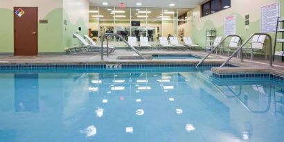 The indoor pool at Sonesta Milwaukee West Wauwatosa has an adjacent hot tub, sun loungers by the side, and is next to the fitness center.