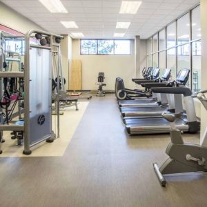 Sonesta Milwaukee West Wauwatosa’s fitness center is equipped with gym balls and various types of exercise machines.