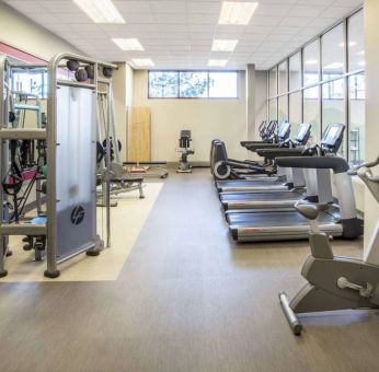 Sonesta Milwaukee West Wauwatosa’s fitness center is equipped with gym balls and various types of exercise machines.