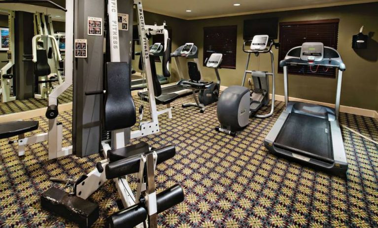 Sonesta ES Suites Dallas Las Colinas’ fitness center has a wall-mounted television and assorted exercise machines for guests to use.