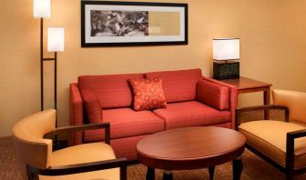 Sonesta Select Detroit Auburn Hills guest room living area, including two chairs, coffee tables, and a sofa.