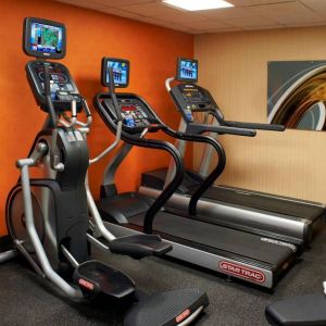 The hotel fitness center has art on the wall and a range of exercise equipment, including treadmills and an elliptical.