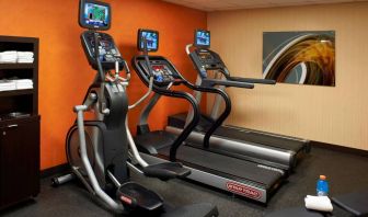 The hotel fitness center has art on the wall and a range of exercise equipment, including treadmills and an elliptical.