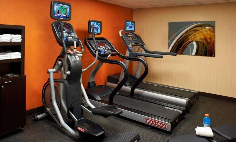 The hotel fitness center has art on the wall and a range of exercise equipment, including treadmills and an elliptical.