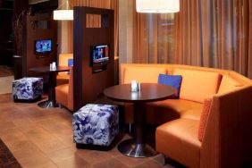 The media pods at Sonesta Select Detroit Auburn Hills are cozy nooks, with each featuring comfy seating, a coffee table, and a TV.