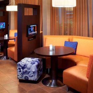 The media pods at Sonesta Select Detroit Auburn Hills are cozy nooks, with each featuring comfy seating, a coffee table, and a TV.