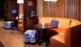 The media pods at Sonesta Select Detroit Auburn Hills are cozy nooks, with each featuring comfy seating, a coffee table, and a TV.