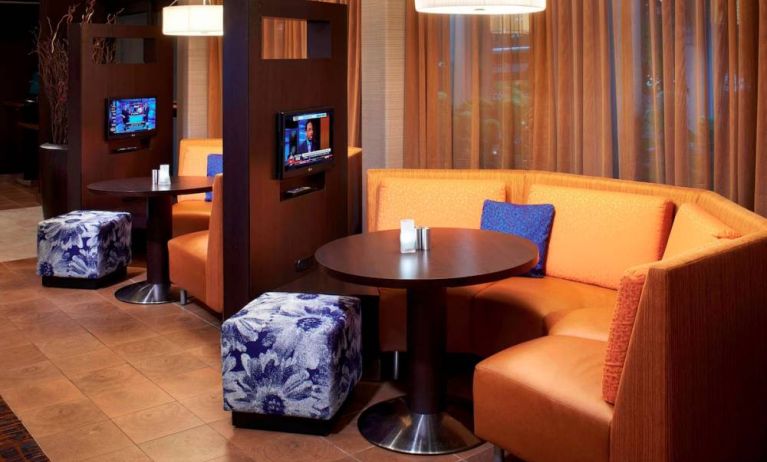 The media pods at Sonesta Select Detroit Auburn Hills are cozy nooks, with each featuring comfy seating, a coffee table, and a TV.