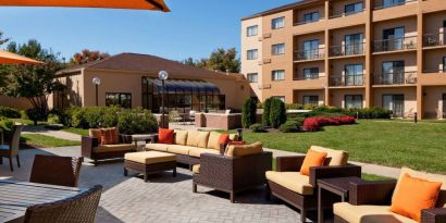 The hotel’s patio has armchairs and sofas, with coffee tables, as well as shaded tables and chairs.