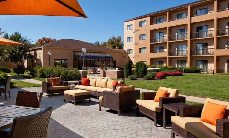 The hotel’s patio has armchairs and sofas, with coffee tables, as well as shaded tables and chairs.