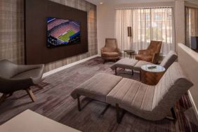 The hotel’s lobby features reclined seats facing a large, wall-mounted TV.