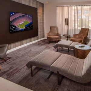 The hotel’s lobby features reclined seats facing a large, wall-mounted TV.