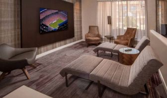 The hotel’s lobby features reclined seats facing a large, wall-mounted TV.