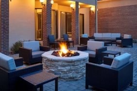 Sonesta Select Indianapolis Carmel’s patio features a fire pit and armchairs, plus coffee tables and sofa seating.