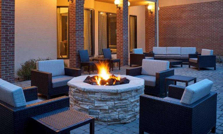 Sonesta Select Indianapolis Carmel’s patio features a fire pit and armchairs, plus coffee tables and sofa seating.