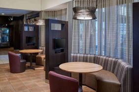 Sonesta Select Indianapolis Carmel’s media pods each feature a TV, coffee table, and comfortable seating next to a window.