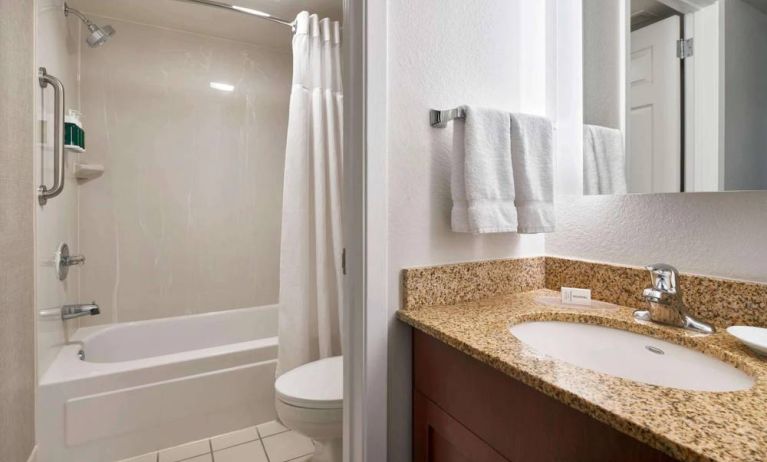 Sonesta ES Suites Annapolis guest bathroom, including a shower-equipped bath, lavatory, mirror, and sink.