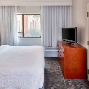 Double bed guest room in Sonesta Select Raleigh Durham Airport Morrisville, featuring a window and a television.