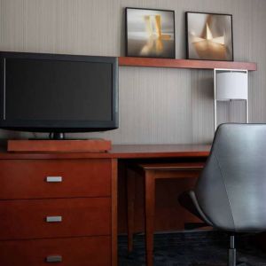 Sonesta Select Phoenix Camelback guest room workspace, including desk, chair, and lamp, plus a TV.