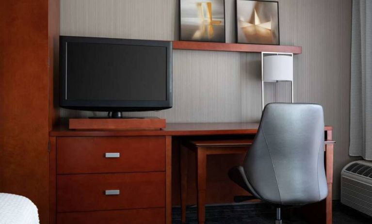 Sonesta Select Phoenix Camelback guest room workspace, including desk, chair, and lamp, plus a TV.