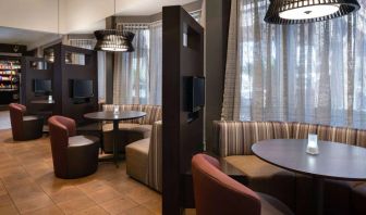 The hotel’s media pods offer a cozy space for co-working, and each has comfy seating, a coffee table, and a television.