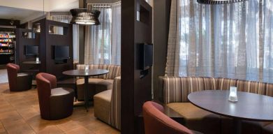 The hotel’s media pods offer a cozy space for co-working, and each has comfy seating, a coffee table, and a television.