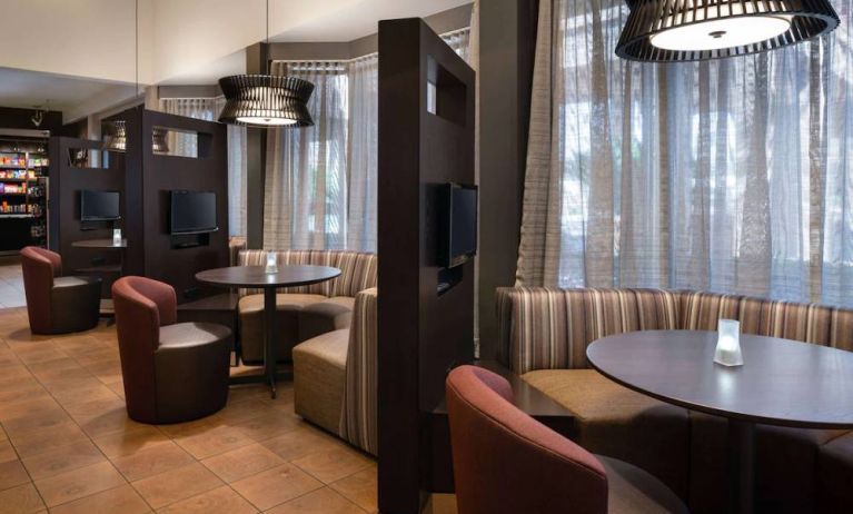 The hotel’s media pods offer a cozy space for co-working, and each has comfy seating, a coffee table, and a television.