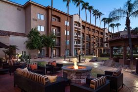 Sonesta Select Phoenix Camelback’s patio features a fire pit surrounded by armchair and sofa seating.