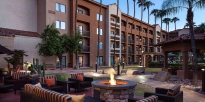 Sonesta Select Phoenix Camelback’s patio features a fire pit surrounded by armchair and sofa seating.