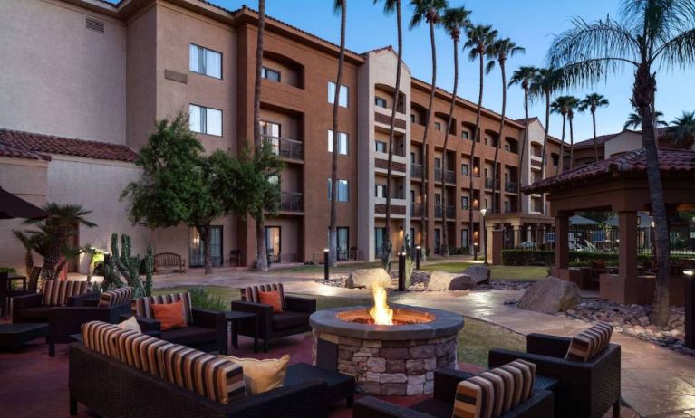 Sonesta Select Phoenix Camelback’s patio features a fire pit surrounded by armchair and sofa seating.