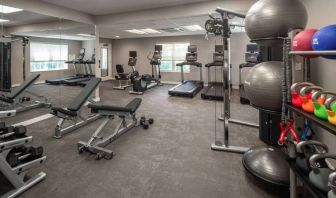 The fitness center at Sonesta ES Suites Fairfax Fair Lakes is equipped with dumbbells, kettlebells, gym balls, and assorted exercise machines.