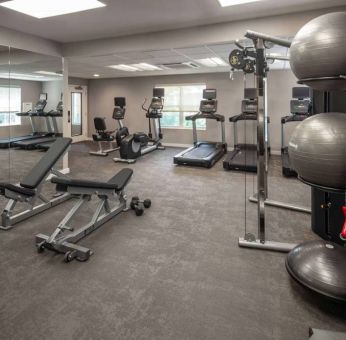 The fitness center at Sonesta ES Suites Fairfax Fair Lakes is equipped with dumbbells, kettlebells, gym balls, and assorted exercise machines.