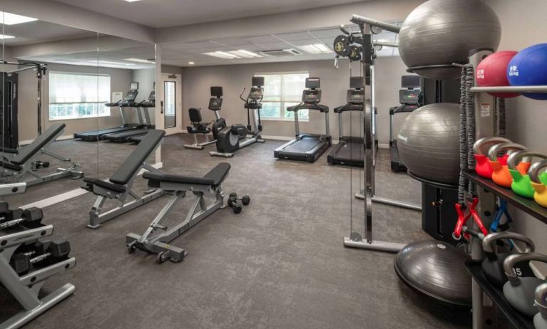 The fitness center at Sonesta ES Suites Fairfax Fair Lakes is equipped with dumbbells, kettlebells, gym balls, and assorted exercise machines.