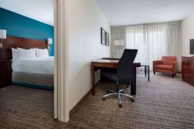 Sonesta ES Suites Dallas Medical Market Center double bed guest room, including a workspace desk and chair.