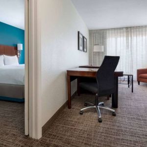 Sonesta ES Suites Dallas Medical Market Center double bed guest room, including a workspace desk and chair.