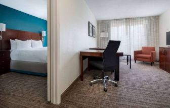 Sonesta ES Suites Dallas Medical Market Center double bed guest room, including a workspace desk and chair.