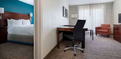 Sonesta ES Suites Dallas Medical Market Center double bed guest room, including a workspace desk and chair.