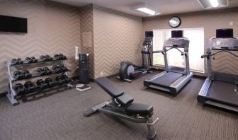 Sonesta ES Suites Dallas Medical Market Center’s fitness center has an assortment of exercise equipment including free weights, and a wall-mounted television.