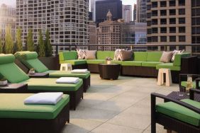 Royal Sonesta Chicago River North’s patio is furnished with chairs, loungers, and sofas, and offers city views.