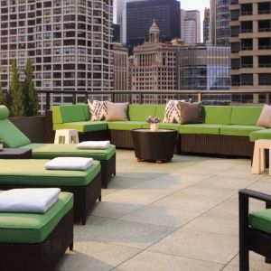 Royal Sonesta Chicago River North’s patio is furnished with chairs, loungers, and sofas, and offers city views.