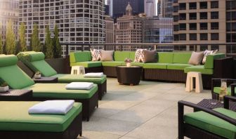 Royal Sonesta Chicago River North’s patio is furnished with chairs, loungers, and sofas, and offers city views.