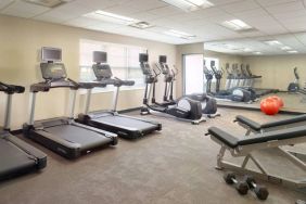 Sonesta ES Suites Raleigh Durham Airport Morrisville’s fitness center is equipped with free weights, benches, and various exercise machines.