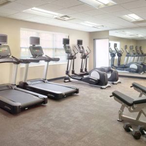 Sonesta ES Suites Raleigh Durham Airport Morrisville’s fitness center is equipped with free weights, benches, and various exercise machines.