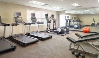 Sonesta ES Suites Raleigh Durham Airport Morrisville’s fitness center is equipped with free weights, benches, and various exercise machines.