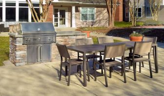 Barbecue with table and six chairs nearby at Sonesta ES Suites Raleigh Durham Airport Morrisville.