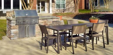 Barbecue with table and six chairs nearby at Sonesta ES Suites Raleigh Durham Airport Morrisville.