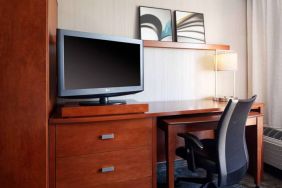 Guest room workspace desk, chair, lamp, and TV at Sonesta Select Kansas City Airport Tiffany Springs.